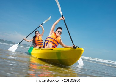Cheerful couple paddling in kayak