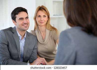 Cheerful Couple Receiving Good News From Advisor