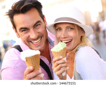 Cheerful Couple In Rome Eating Ice Cream Cones