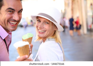 Cheerful Couple In Rome Eating Ice Cream Cones