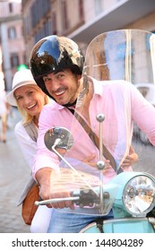 Cheerful Couple In Rome Riding Scooter