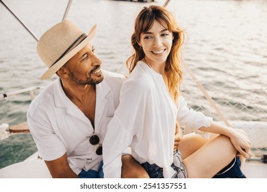 A cheerful couple shares a romantic moment while sailing on a boat during sunset, embracing joy and love.  - Powered by Shutterstock