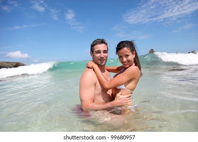 Cheerful Couple Swimming In The Ocean