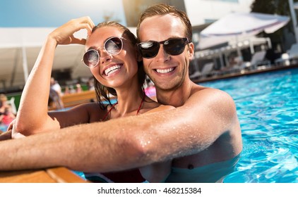 Cheerful Couple Swimming In A Pool