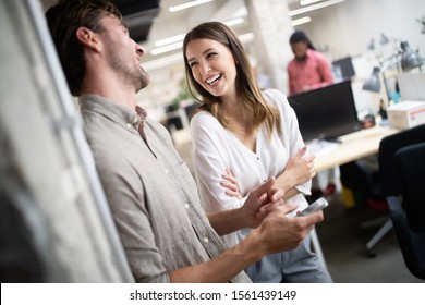 Cheerful coworkers in office during company meeting - Powered by Shutterstock