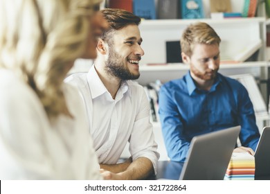 Cheerful coworkers in office during company meeting