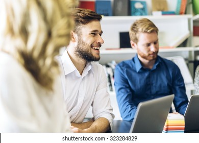 Cheerful Coworkers In Office During Company Meeting