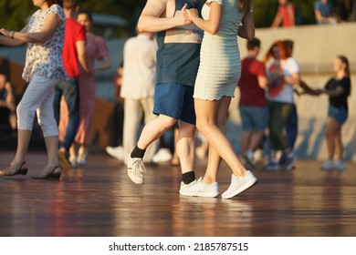 Cheerful Dancing Couples Of Young Man And Woman In Public Park. Lifestyle Theme. Having Fun People. Low Angle View