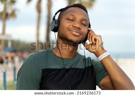 Similar – Young happy black man is listening to music