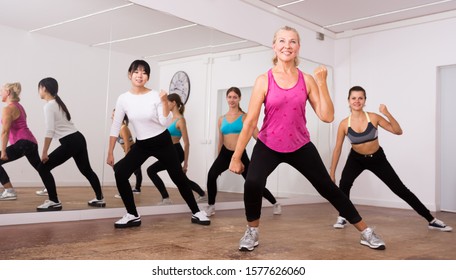 Cheerful Different Ages Women Learning Swing Steps At Dance Class