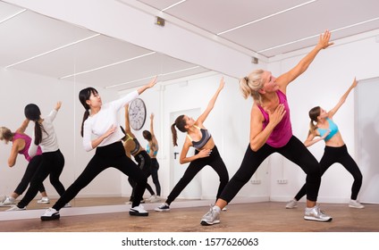 Cheerful Different Ages Women Learning Swing Steps At Dance Class