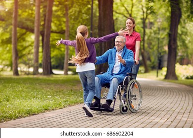 cheerful disabled grandfather in wheelchair welcoming his happy granddaughter
 - Powered by Shutterstock