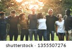 Cheerful diverse people huddling in the park