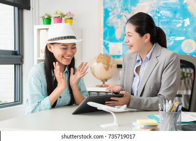cheerful elegant female customer feeling happy when travel agent company manager woman using mobile pad computer showing special price for her.