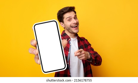 Cheerful Emotional Man Holding Big Blank Cell Phone In Hand Showing White Screen To Camera Pointing At You, Happy Millennial Guy Recommending New Application Or Mobile Website, Mockup Banner Collage - Shutterstock ID 2136178755