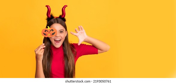 cheerful evil child in imp horns. happy halloween. devil kid with pumpkin party accessory. Halloween kid girl portrait, horizontal poster. Banner header with copy space. - Shutterstock ID 2193050761