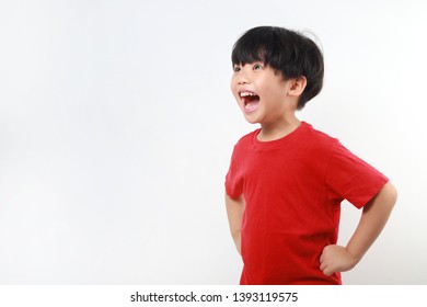 Cheerful And Excited Asian Boy Screaming On White Background