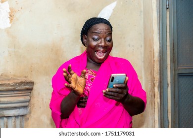 Cheerful Excited Old Black African Woman Receiving Some Good News With Her Smart Phone.happy Senior Lady Using Mobile Phone