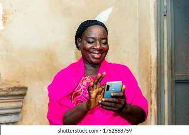 Cheerful Excited Old Black African Woman Receiving Some Good News With Her Smart Phone.happy Senior Lady Using Mobile Phone