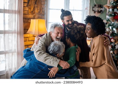 Cheerful extended multiethnic family having fun while celebrating Christmas together at home. - Powered by Shutterstock