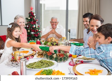 Cheerful Family At Dining Table For Christmas Dinner In The House