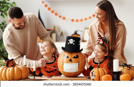 Cheerful family   makes jack o lantern  in medical masks out of a pumpkin and  decorates house  in cozy kitchen during Halloween celebration at home during the covid19 coronavirus pandemic
 - Powered by Shutterstock