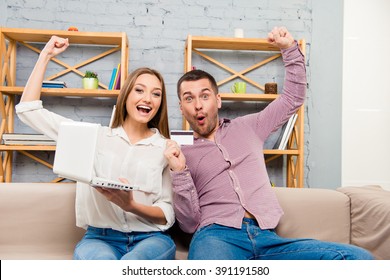 Cheerful family making internet shopping with laptop and bank card