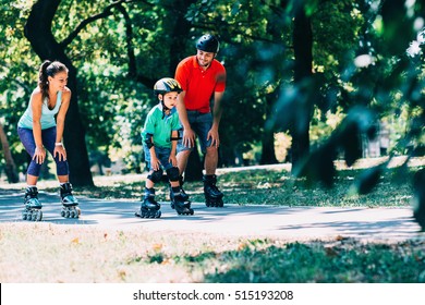 Cheerful family roller skating in park
