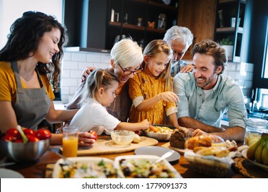 Cheerful family spending good time together while cooking in kitchen - Powered by Shutterstock