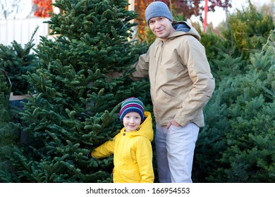 Cheerful Family Of Two Buying Christmas Tree Together