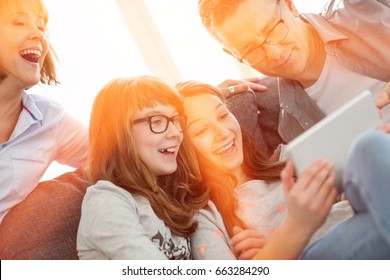 Cheerful Family Using Tablet PC At Home