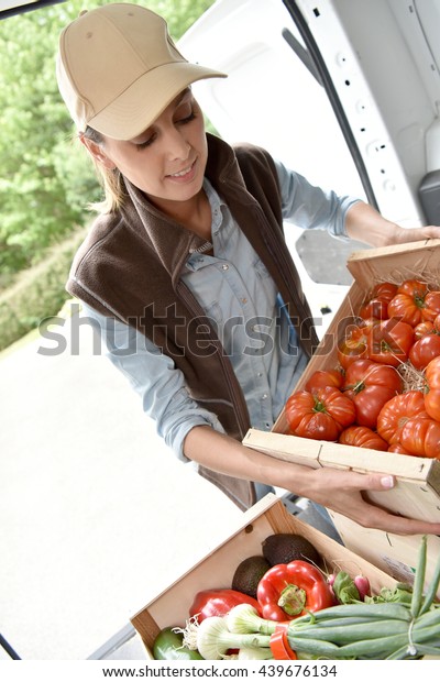 Cheerful farmer\
delivering fresh\
vegetables