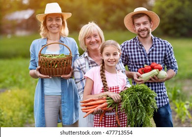 Cheerful Farmer Family With Organic Grown Vegetables 