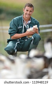 Cheerful Farmer Holding Duck In His Arms