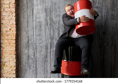 Cheerful Fat Caucasian Businessman Is Not Ready To Give Someone His Profit On Oil Production, Man Hugs Red Oil Barrel