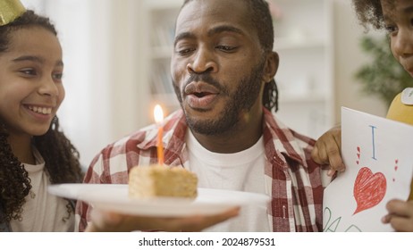 Cheerful Father Blowing Out Birthday Cake Candle, Hugging Caring Daughters, Family