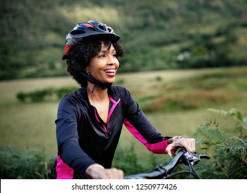 Cheerful Female Cyclist Enjoying A Bike Ride