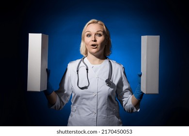 Cheerful Female Doctor Holding White Boxes In Her Hands On A Dark Background