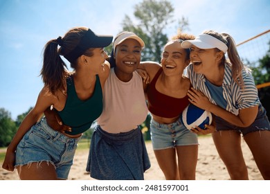 Cheerful female friends having fun in summer day while playing beach volleyball.  - Powered by Shutterstock