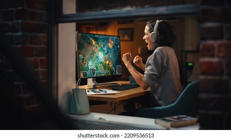 Cheerful Female Gamer Playing Online Video Game On Personal Computer. Professional Woman Player Enjoying Fantasy RPG And Celebrating Victory. Role Playing Character Casting Magic Spells. Window View.