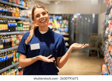 Cheerful female store worker in uniform smiling and gesturing toward supermarket shelves. Concept of customer service, helpful staff, product promotion and retail shopping experience. - Powered by Shutterstock - Get 15% off with code: PIKWIZARD15