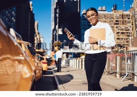 cheerful female waiting for call from operator with information about time of arrival taxi