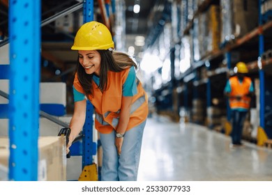 Cheerful female warehouse worker scans a package in a bustling distribution center, dressed in safety gear among neatly organized shelves. The image captures the fast paced logistics industry - Powered by Shutterstock