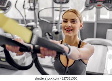 Cheerful Female Working Out In Fitness Center