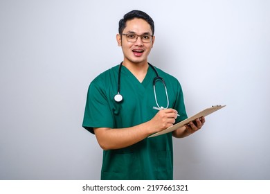 Cheerful Friendly Asian Male Physician, Doctor With Clipboard During Daily Checkup, Standing Over Isolated White Background