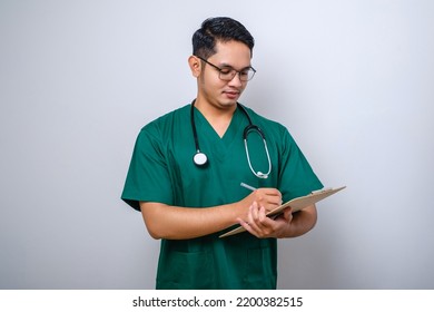 Cheerful Friendly Asian Male Physician, Doctor With Clipboard During Daily Checkup, Standing Over Isolated White Background