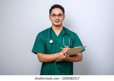 Cheerful Friendly Asian Male Physician, Doctor With Clipboard During Daily Checkup, Standing Over Isolated White Background