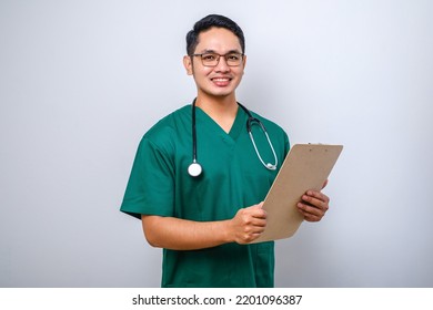 Cheerful Friendly Asian Male Physician, Doctor With Clipboard During Daily Checkup, Standing Over Isolated White Background