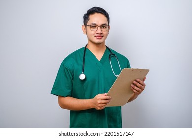 Cheerful Friendly Asian Male Physician, Doctor With Clipboard During Daily Checkup, Standing Over Isolated White Background