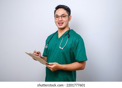 Cheerful Friendly Asian Male Physician, Doctor With Clipboard During Daily Checkup, Standing Over Isolated White Background